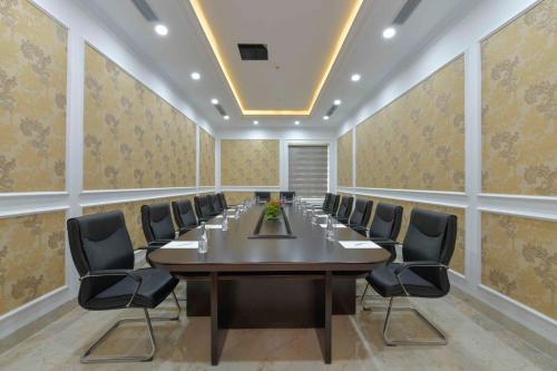 a conference room with a long table and chairs at Eden Ocean View Hotel Da Nang in Da Nang