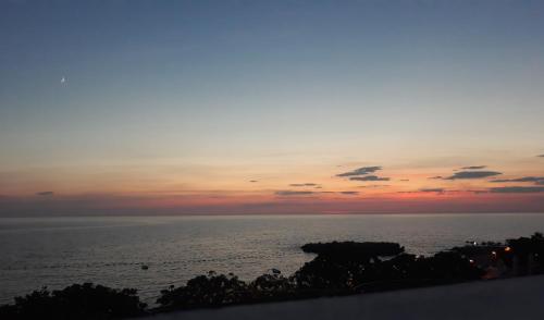 a sunset over the ocean with the sky at Queen Apartments & Rooms in Dobra Voda