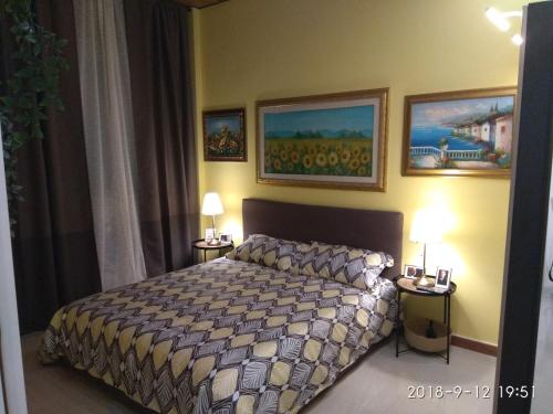 a bedroom with a bed and two tables with lamps at Milan center Luxury House in Sesto San Giovanni