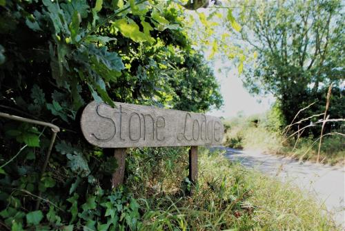 a sign that says some logic on the side of a road at Stone Lodge in Holt
