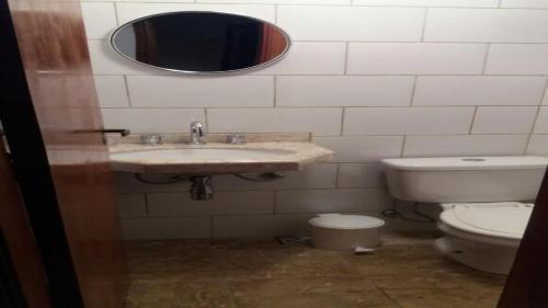 a bathroom with a sink and a toilet at Casa em Monte Verde in Monte Verde