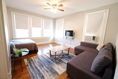 a living room with a couch and a bed at Global Cup The 1920s Mainstay Studio Flat on Lower Greenville in Dallas
