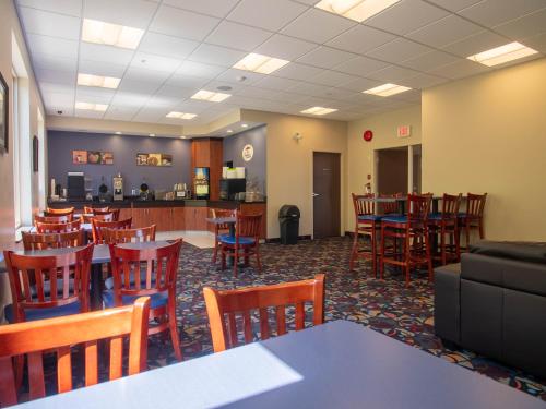 a restaurant with tables and chairs and a bar at Super 8 by Wyndham Kamloops On The Hill in Kamloops