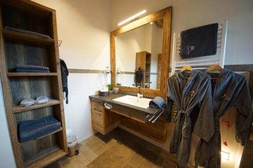 a bathroom with a sink and a large mirror at Kaiserappartements-Marie in Ellmau