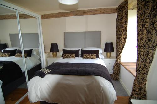 a bedroom with two beds and a large window at Gites Bijoux in Argouges