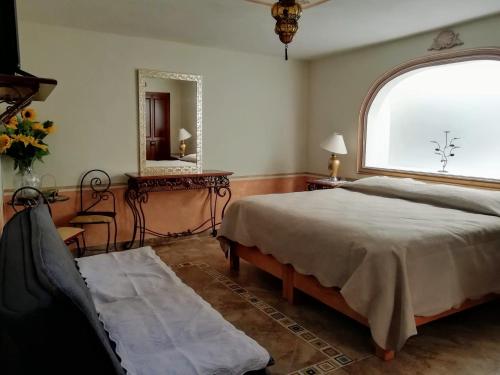 En eller flere senger på et rom på Hotel Posada Maria Bonita