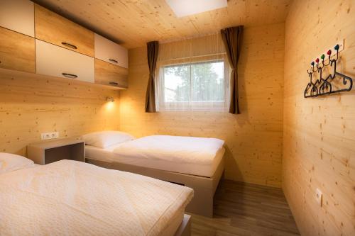 a room with two beds and a window at Pearl of Sava Wild Waters in Ljubljana