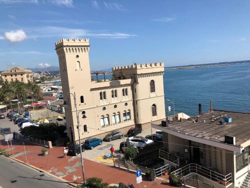 a large white building next to a body of water at La Casetta di Dory sul Mare in Genova