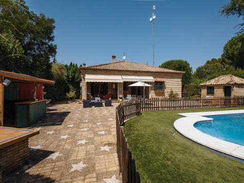 a backyard with a swimming pool and a house at Divi Apartments Villa Reyes in Mairena del Aljarafe