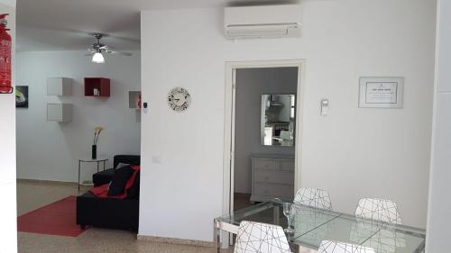 a living room with a glass table and a mirror at La Castillo in Santa Cruz de Tenerife