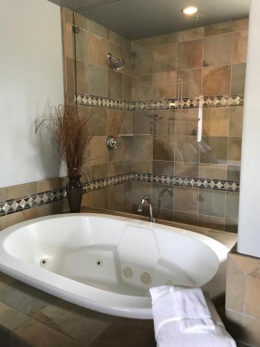 a white bath tub sitting in a bathroom at Secrets Inn Lake Tahoe in South Lake Tahoe