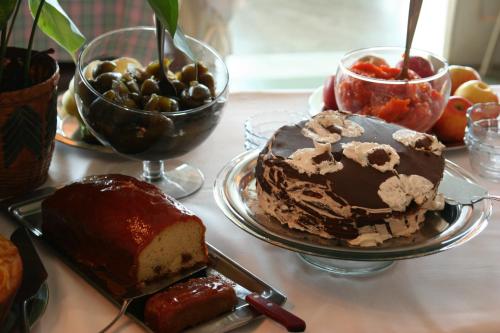 a table with a cake and other desserts on it at Hotel Dominguez Master in Nova Friburgo