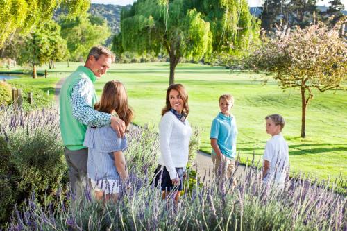 a family posing for a picture in a field at Quail Lodge & Golf Club in Carmel