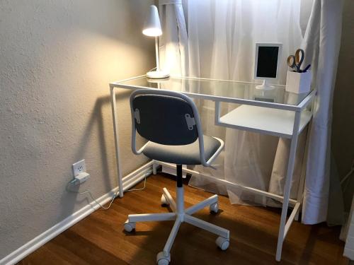 a desk with a chair and a desk with a computer at Long Beach House in Long Beach