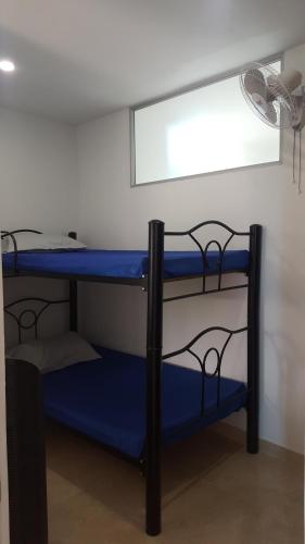 two bunk beds in a room with a fan at Condominio Santa Hagia Sofia - Casa y 2 apartamentos in Flandes