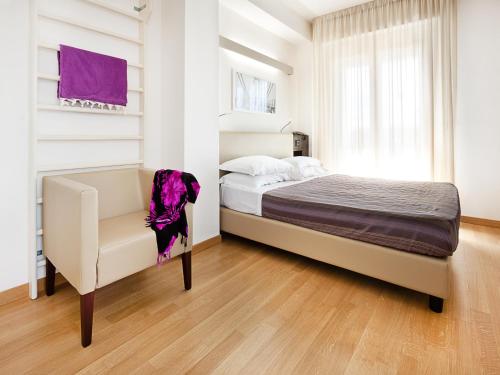 a bedroom with a bed and a desk at Hotel Sporting in San Benedetto del Tronto