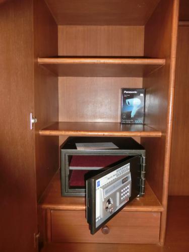 a cabinet with a toaster oven inside of it at The Narima - SHA Plus in Ko Lanta