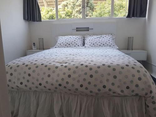 a bedroom with a large bed with polka dot sheets at WTC Loft Nápoles El Segundo Cielo in Mexico City