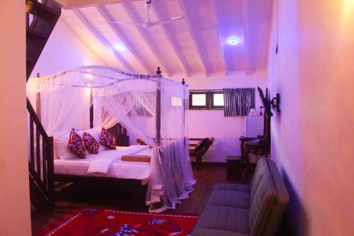 a bedroom with a bed with a canopy at Dream Villa Galle Fort in Galle