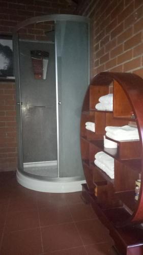 a bathroom with a shower and a sink with towels at Tam Tinh Vien Homestay in Hue