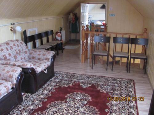 a living room with a couch and a table and chairs at Ziedu pasaule in Krāslava