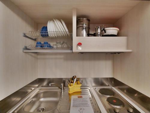 a kitchen sink with a yellow bag sitting on it at Hotel Residence Mondial in Moneglia