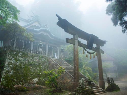 a sign in front of a building in the fog at Yunotani Senkei in Totsukawa