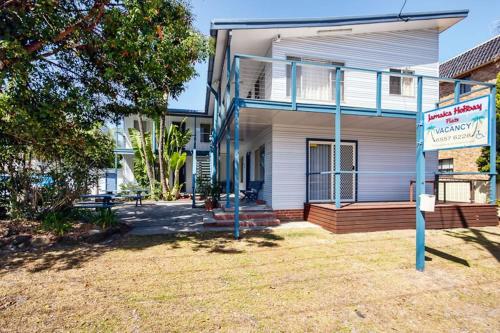 a house with a sign on the front of it at Jamaica Holiday Units in Forster