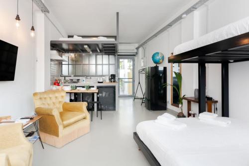 a bedroom with a bunk bed and a kitchen at Monastiraki Factory Living- Unspoiled Athens Apartments in Athens