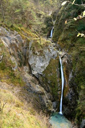 a couple of waterfalls on a rocky hillside at Apartment Sotočje in Dolenja Trebuša