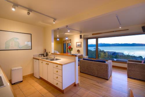 a kitchen with a sink and a large window at The Wheelhouse Inn in Nelson