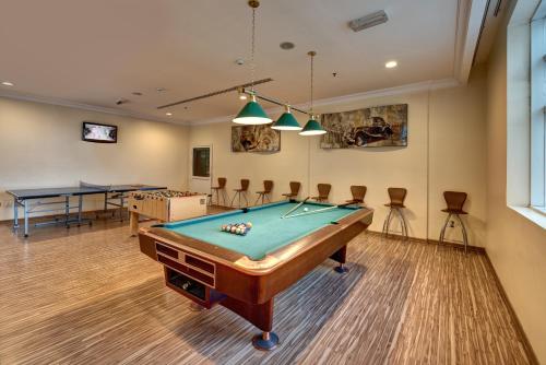 a room with a pool table and ping pong balls at Sharjah Palace Hotel in Sharjah