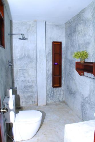 a bathroom with a toilet and a sink at Villa 45 - Balapitiya in Balapitiya