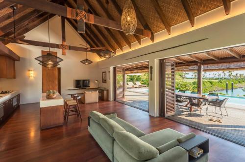 an open living room with a couch and a table at Six Senses Fiji in Malolo