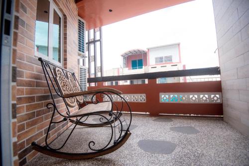 a bench sitting on the balcony of a building at Ripoll'es Homestay in Chishang
