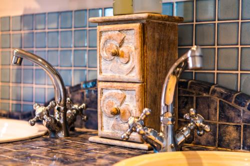 a bathroom counter with two faucets and a sink at Sugar Shack in Paternoster