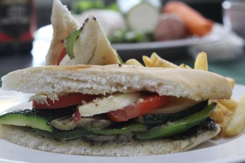 a sandwich and french fries on a white plate at ROKPA Guest House in Kathmandu