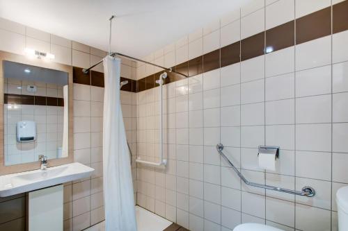 a bathroom with a shower and a toilet and a sink at Vacancéole - Le Privilège in Germ