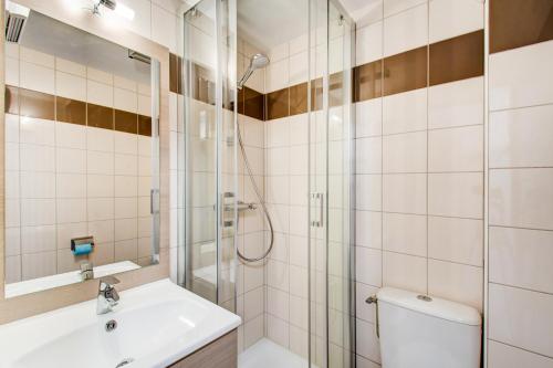 a bathroom with a shower and a sink and a toilet at Vacancéole - Le Privilège in Germ