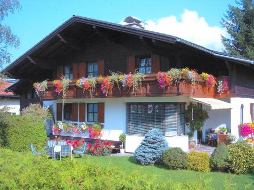 a house with lots of flowers on the balcony at Landhaus Tripolt in Radstadt