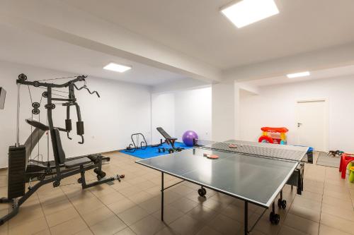 a room with a ping pong table and a gym at Nisos Villa, Pool & Heated SpaWhirlpool, Walking to Beach, By ThinkVilla in Sfakaki