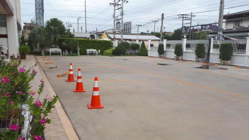 a parking lot with orange and white cones on it at Nut Mansion Suvarnabhumi in Bang Phli