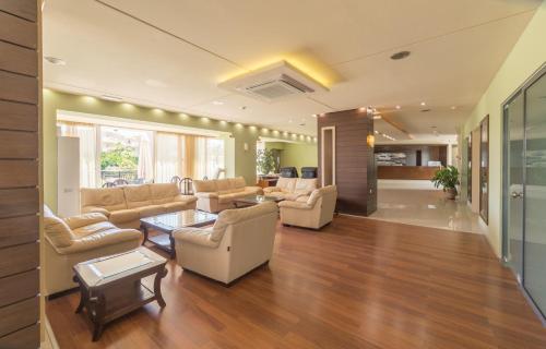 a living room with couches and a table at Atrion Resort Hotel in Agia Marina Nea Kydonias