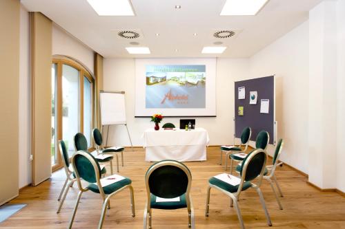 a meeting room with chairs and a table with a white table at Alphotel Innsbruck in Innsbruck