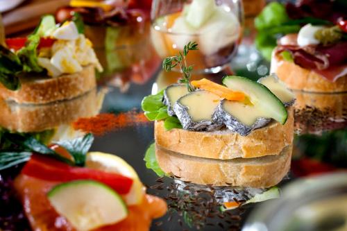 a bunch of small appetizers on a table at Alphotel Innsbruck in Innsbruck