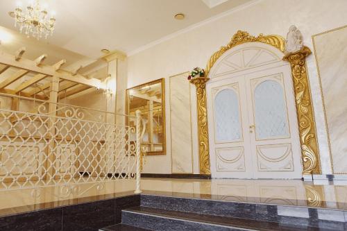 a room with a gold door and a staircase at Ritsa Hall in Krasnodar
