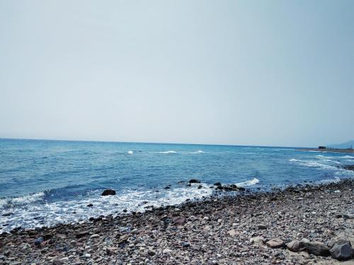a rocky beach with the ocean in the background at SakraTah Camp - eco friendly in Taba