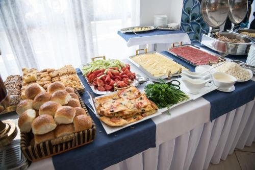 a buffet with many different types of food on a table at Kapriz Issyk Kul Resort in Cholpon-Ata