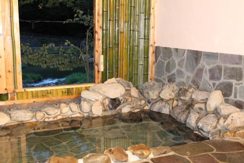 a pool of water in a room with a window at Seiryuso in Misasa