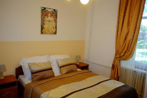 a bedroom with a bed and a window at Leier apartments in Piešťany